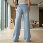 Full view of women's high waist wide leg washed ripped denim jeans